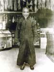 Chinese shopkeeper, shark fins and ducks hanging